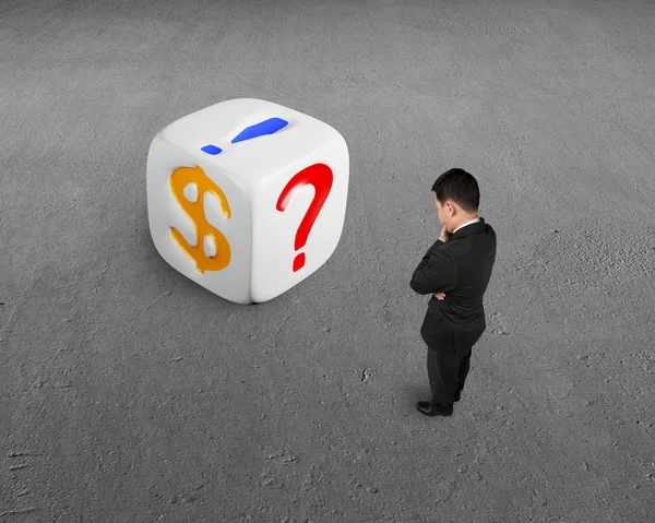 Businessman looking white dice — Stock Photo, Image