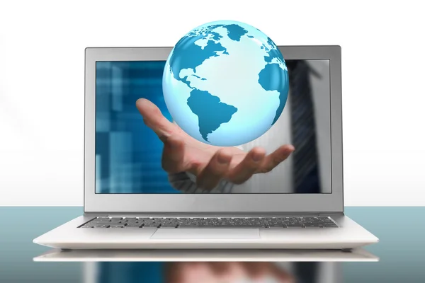 Globe in palm through laptop — Stock Photo, Image