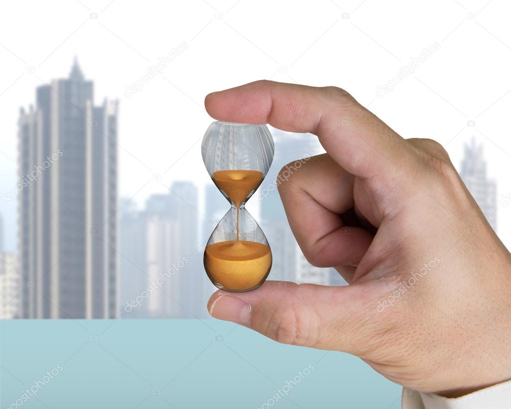 human hand holding hourglass