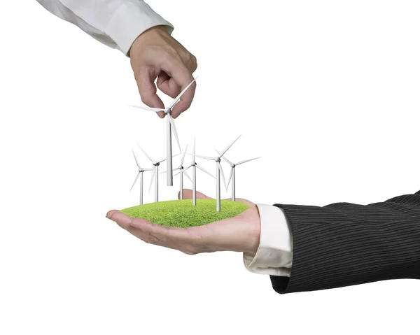 Men hands holding windturbines on grass — Stock Photo, Image