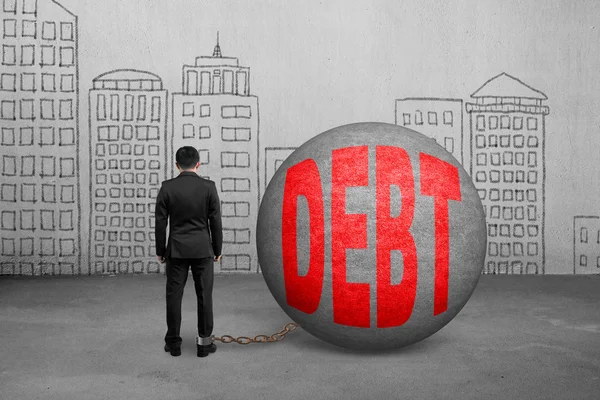 Businessman being trapped with debt ball — Stock Photo, Image