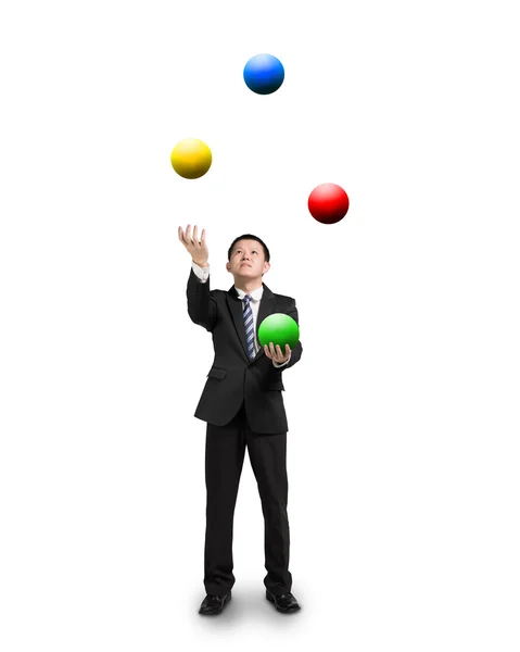 Schwarzer Anzug Geschäftsmann jongliert mit bunten Bällen — Stockfoto