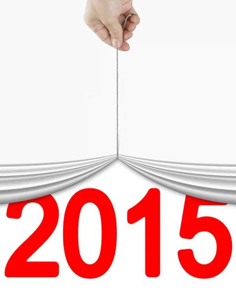 Human hand pulling up white curtain with bright red 2015 — Stock Photo, Image