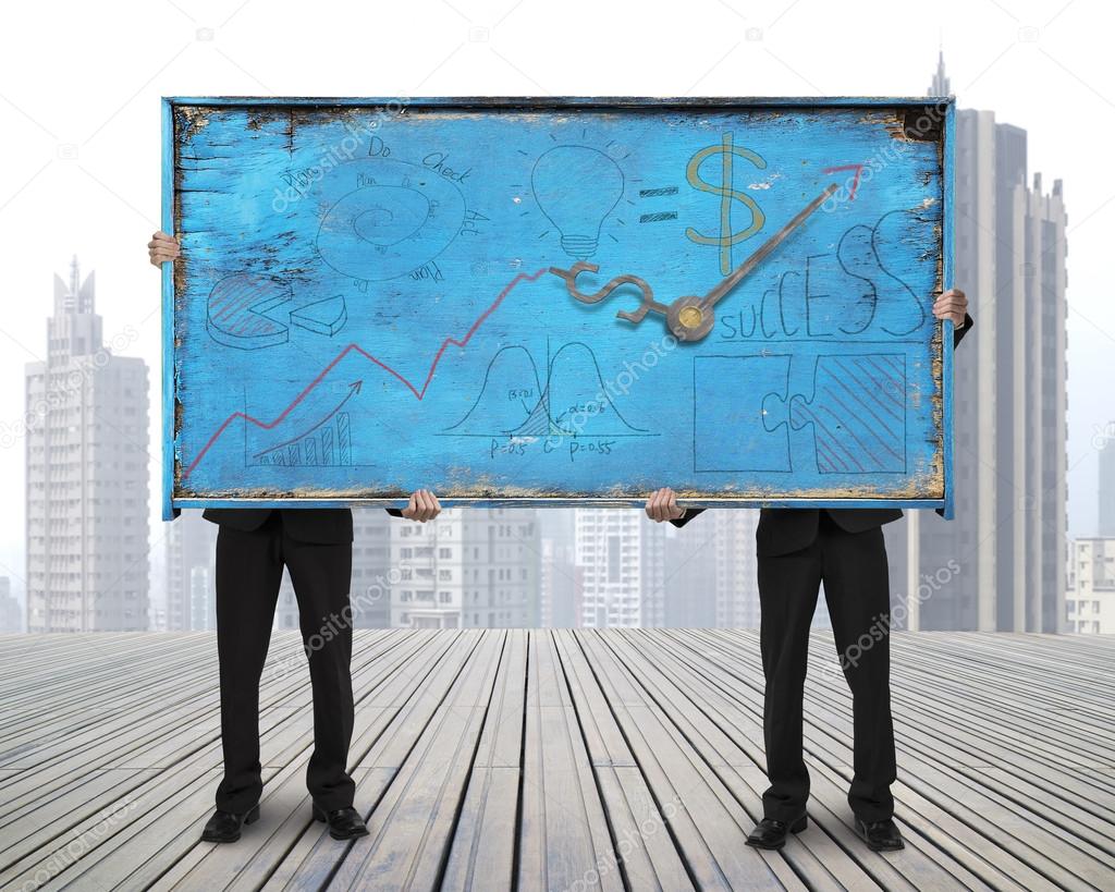 two men holding old blue doodles billboard on skyscraper citysca