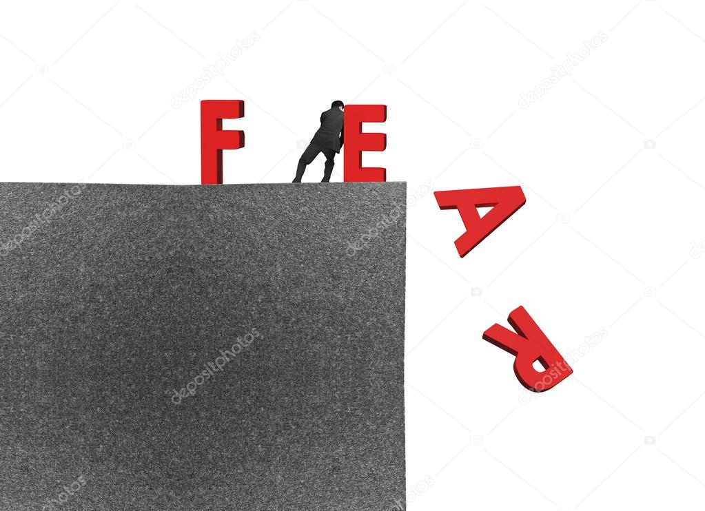 man push red fear word down on top of building