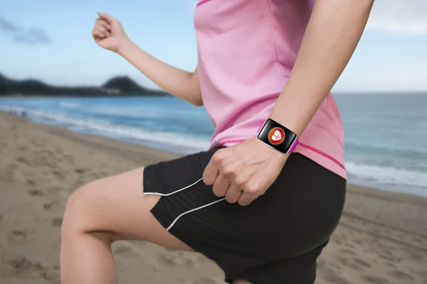 Sportovní ženy nosit světlé růžové watchband ohnuté touchscreen smar — Stock fotografie