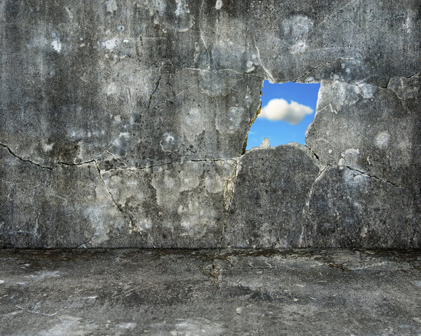 nature sky view through hole on grey grunge concrete wall