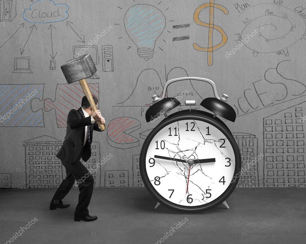 Businessman using sledgehammer hitting alarm clock broken glass Stock