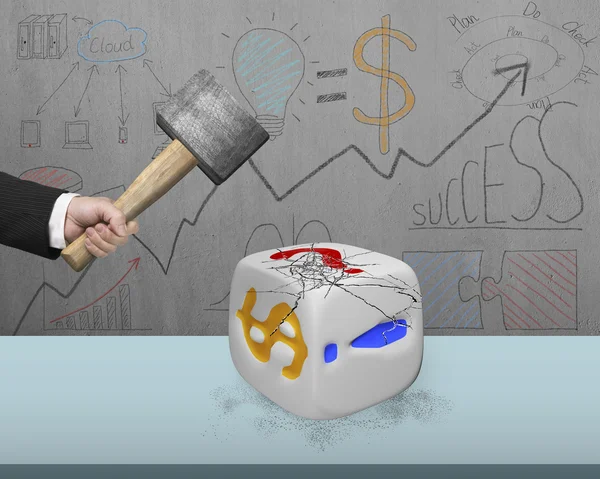 Hand holding sledgehammer hitting white dice with doodles wall — Stock Photo, Image