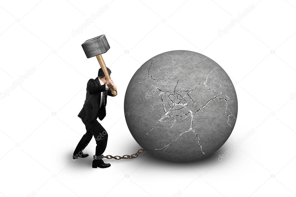 businessman holding hammer hitting cracked concrete ball isolate