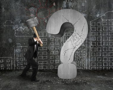 businessman holding hammer cracked question mark with city build