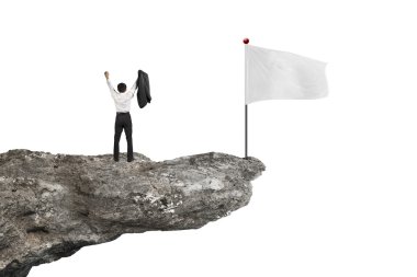 man cheering on cliff with blank flag and white