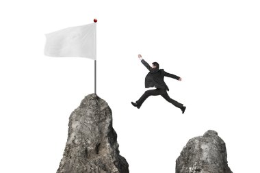 businessman jumping over mountain peak to blank white flag
