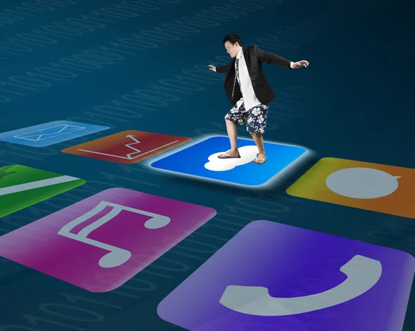 Man standing on shiny cloud icon with colorful app buttons — Stok fotoğraf