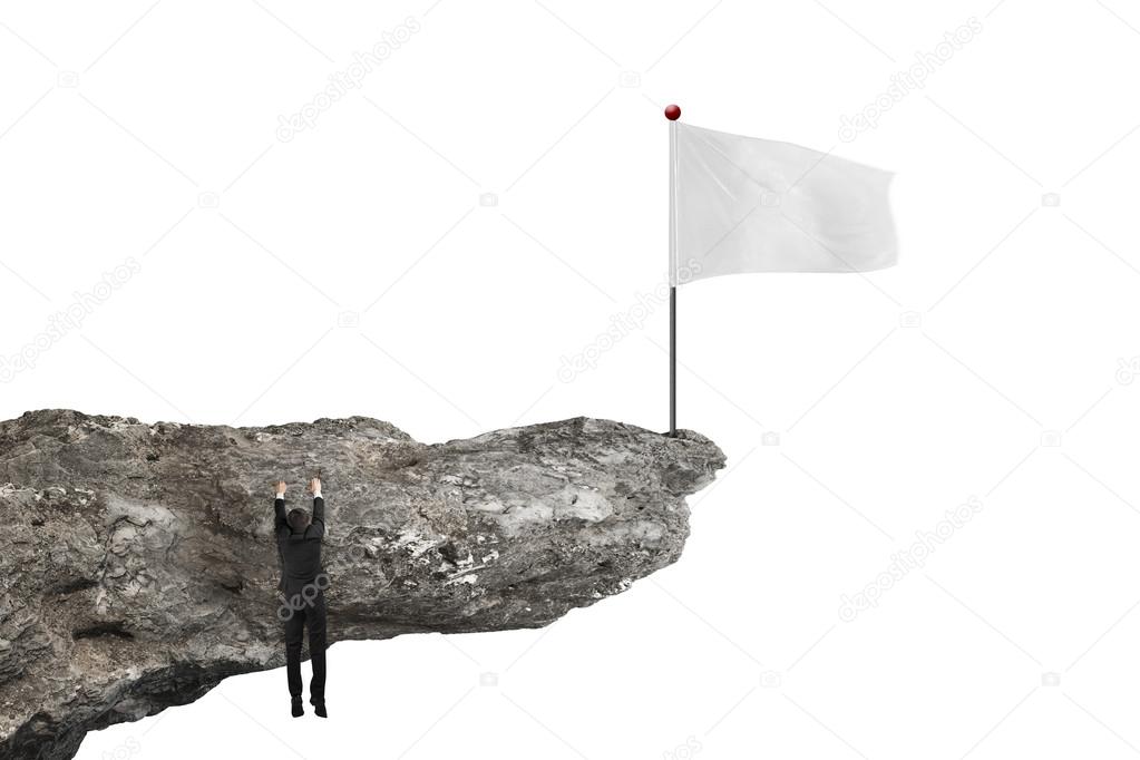 man hanging on cliff with blank flag and white