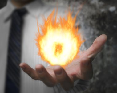 Burning fire ball in man hand