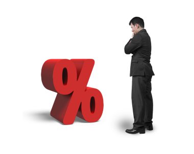 Thinking salesman looking at red percentage sign isolated on whi