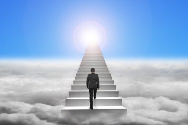 Businessman climbing the concrete stairs with blue sky sunlight 