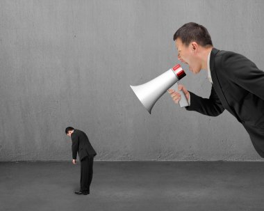 Businessman using megaphone yelling at his employee with concret