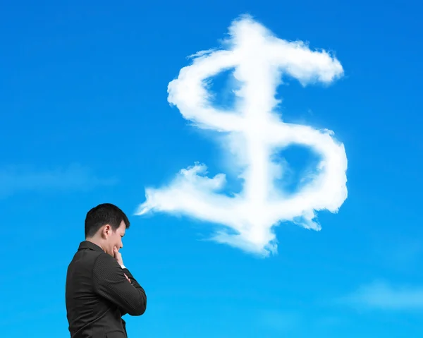 Businessman thinking about dollar sign shape cloud with blue sky — Stock Photo, Image