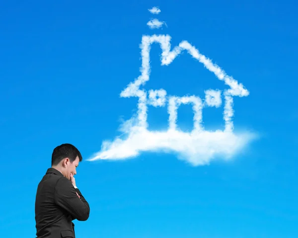 Businessman thinking about house shape cloud with blue sky — Stockfoto