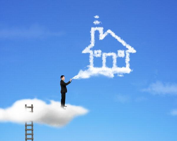 Businessman spraying house shape cloud paint with ladder and sky