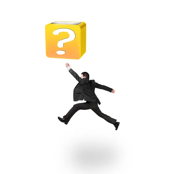 Jumping businessman hitting 3d question mark box isolated on whi — Stok fotoğraf