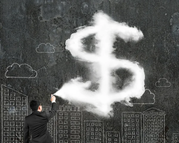 Man spraying dollar sign shape cloud paint wit doodles wall — Stockfoto