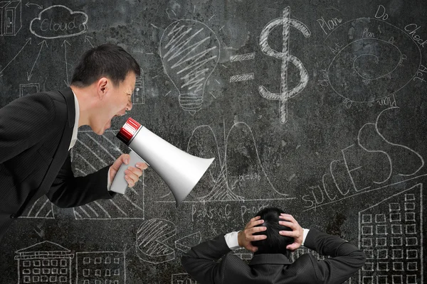 Boss using megaphone yelling at his employee with doodles wall — Φωτογραφία Αρχείου