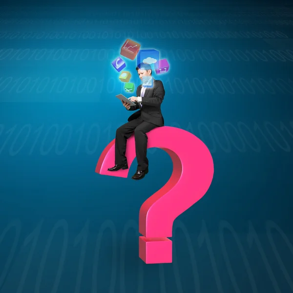 Businessman using tablet on pink question mark with app icons — Stock fotografie