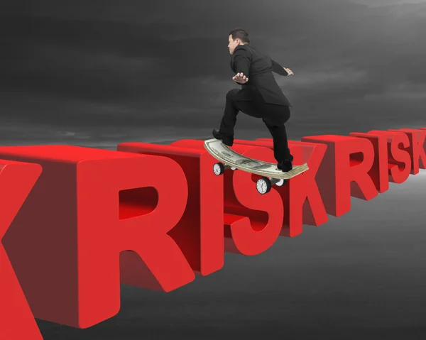 Businessman skating on money skateboard across red risk 3D text — Φωτογραφία Αρχείου
