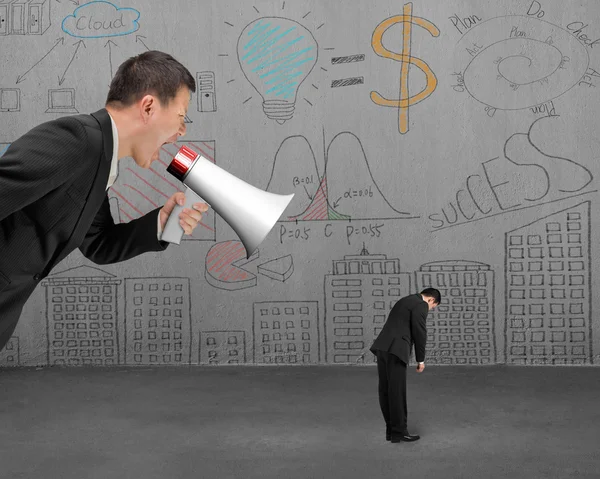 Businessman using megaphone yelling at his employee with doodles — Stock Photo, Image