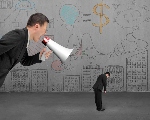 Businessman using megaphone yelling at his employee with doodles — Stock fotografie