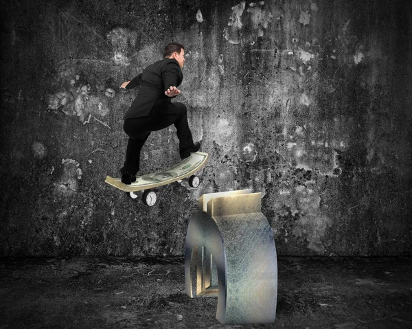 Businessman skating on money skateboard across metal euro symbol — 스톡 사진