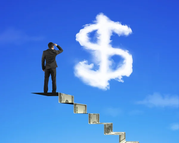 Businessman on money stairs looking at dollar sign shape cloud — Stock Photo, Image