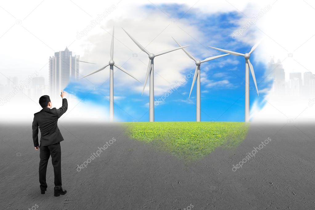 Businessman spraying wind turbines paint covered gray cityscape