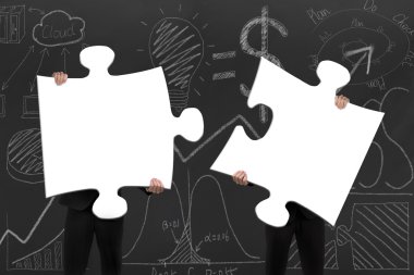 Two business people assembling blank white jigsaw puzzles with d clipart