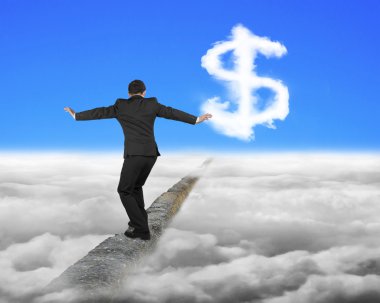 Businessman balancing on ridge with dollar sign cloud and sky