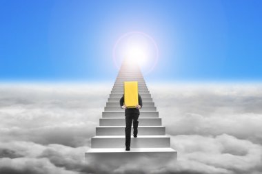 Businessman carrying gold bullion on stairs with sky cloudscape 
