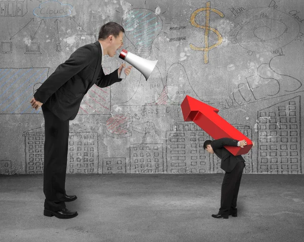 Boss using megaphone yelling at employee carrying red arrow sign — Stok fotoğraf