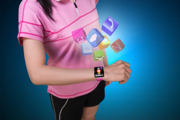 Sport woman wearing touchscreen smartwatch with colorful app ico — Stock Fotó