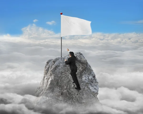 Businessman hand wanting for white flag on peak with cloudscape — Stock Photo, Image