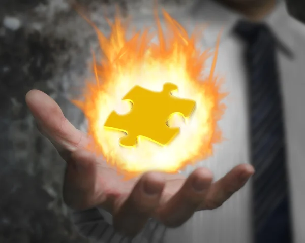 Burning fire ball of jigsaw puzzle in businessman hand — ストック写真