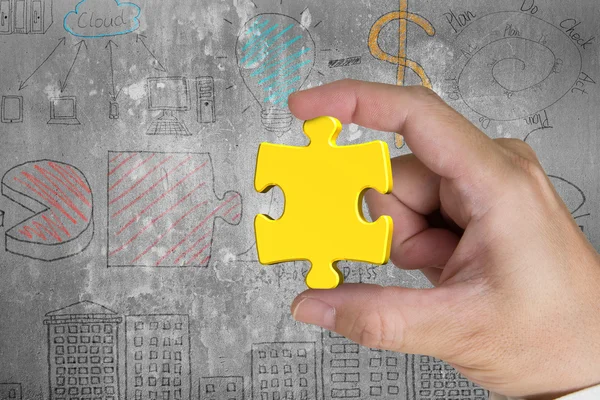 Hand holding gold jigsaw puzzle piece with business concept dood — 图库照片