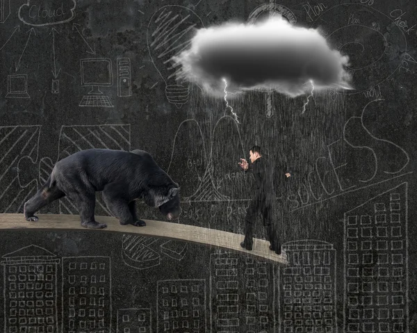 Businessman against bear balancing on plank with gray cloud rain — Zdjęcie stockowe