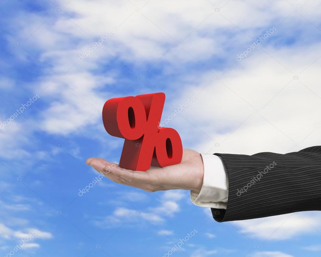 Hand showing 3D red percentage sign with sky cloud background