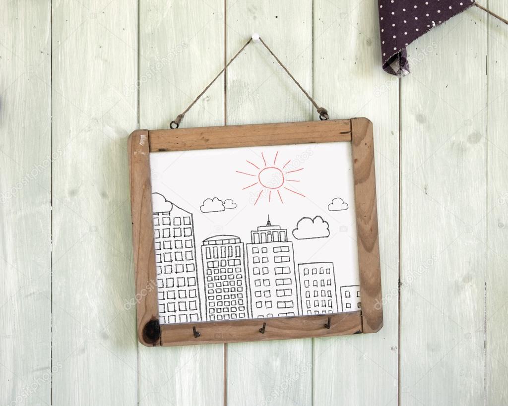 Buildings doodles message board hanging on retro green wooden wa