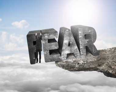 Man hanging fear 3D word edge cliff with sunlight sky