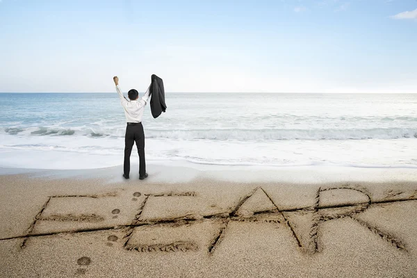 Empresario animando con miedo la palabra borrada línea en la playa de arena — Foto de Stock