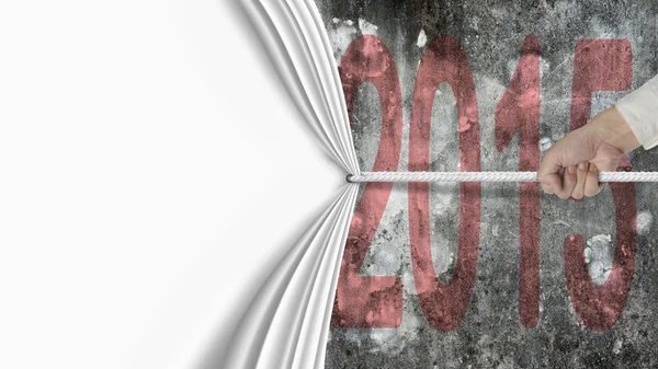 Hand pulling blank white curtain covered dark red 2015 wall